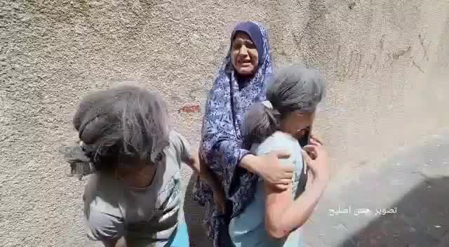 Women and children wail on Gaza street following airstrike